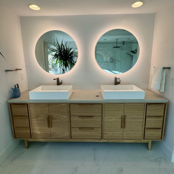 bathroom upgrade featuring backlit his and hers sinks and mirrors